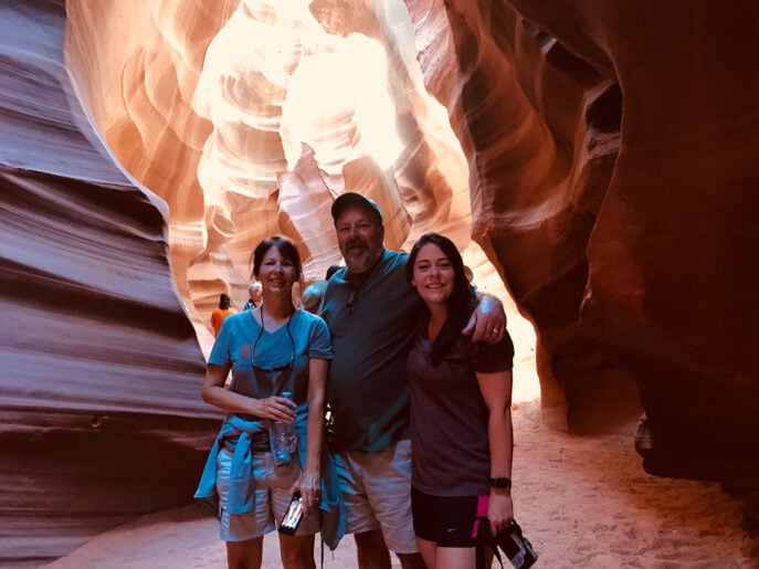 Two women and one man visiting Upper Antelope Canyon at the best time