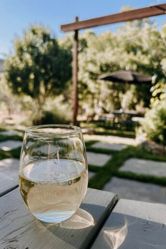 a glass of white wine that reads page spring cellars which is one of the best wineries in Sedona for a Sedona wine tour