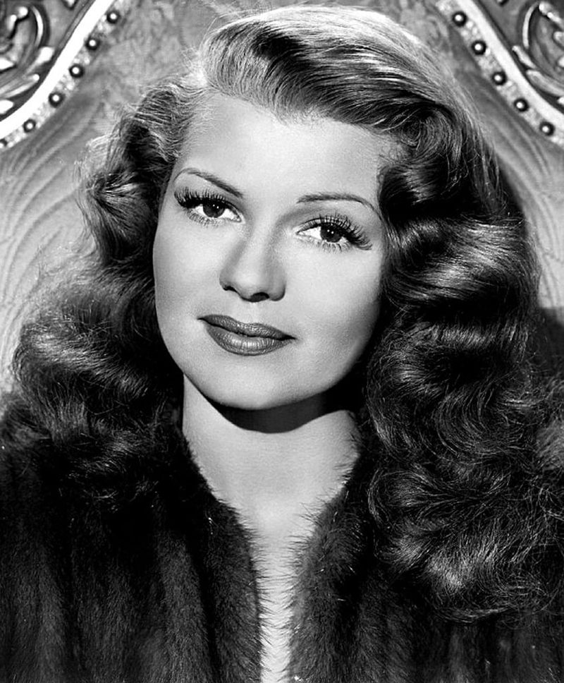Rita Hayworth — The wartime Love Goddess, forever immortalized by the satin gloves and smolder of Gilda.