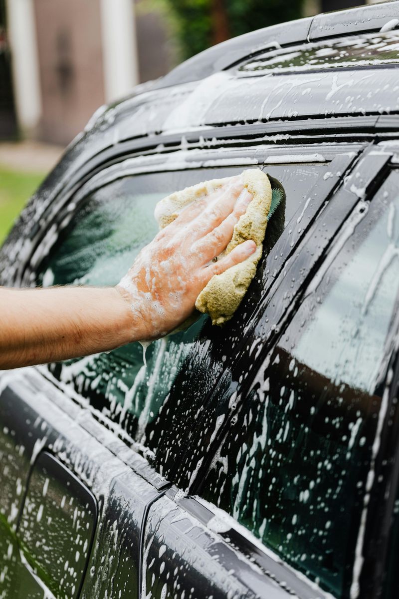 Washing the family car in the driveway
