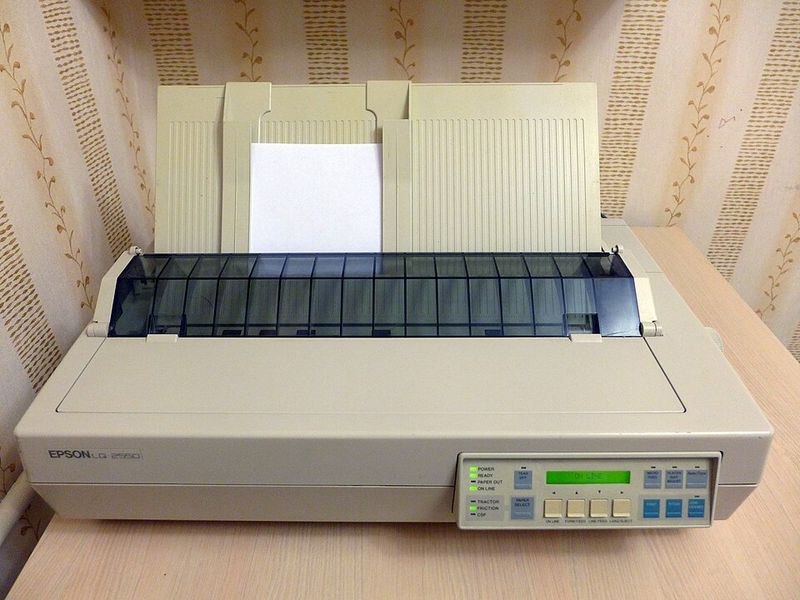 A dot-matrix printer grinding through pages