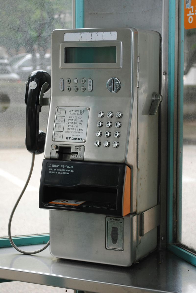Coins clinking inside a payphone
