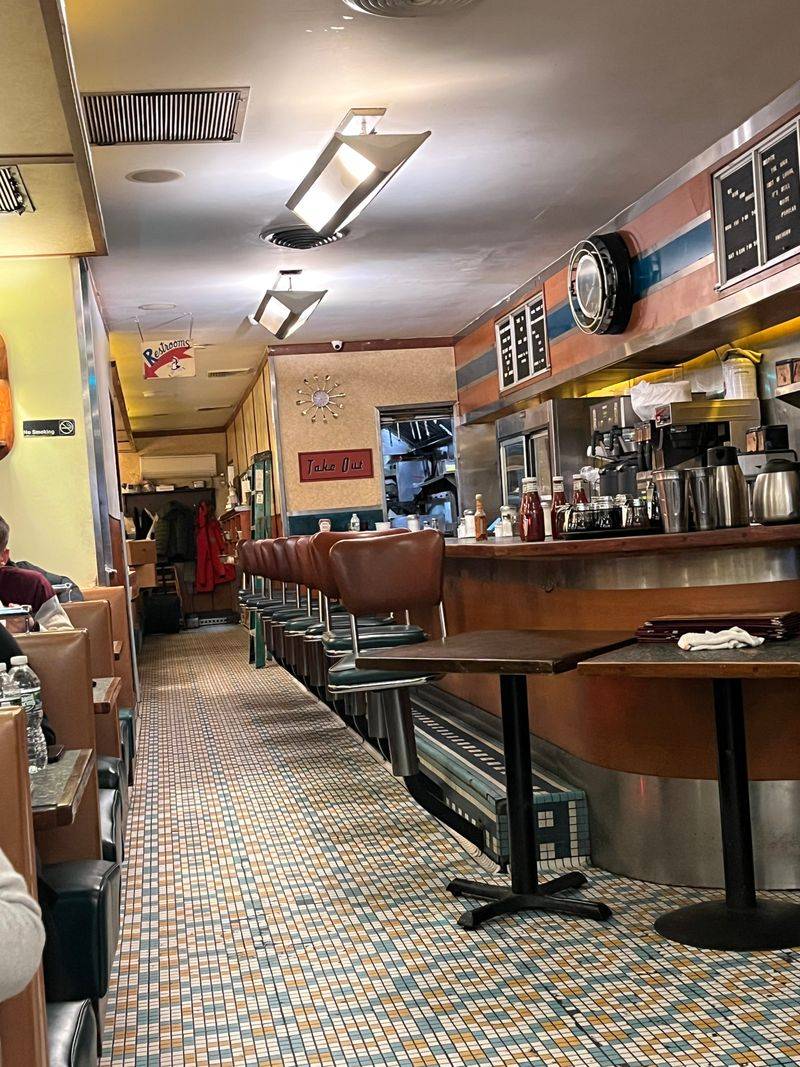 A Retro Welcome: Booths, Counter Stools, And Neon Glow