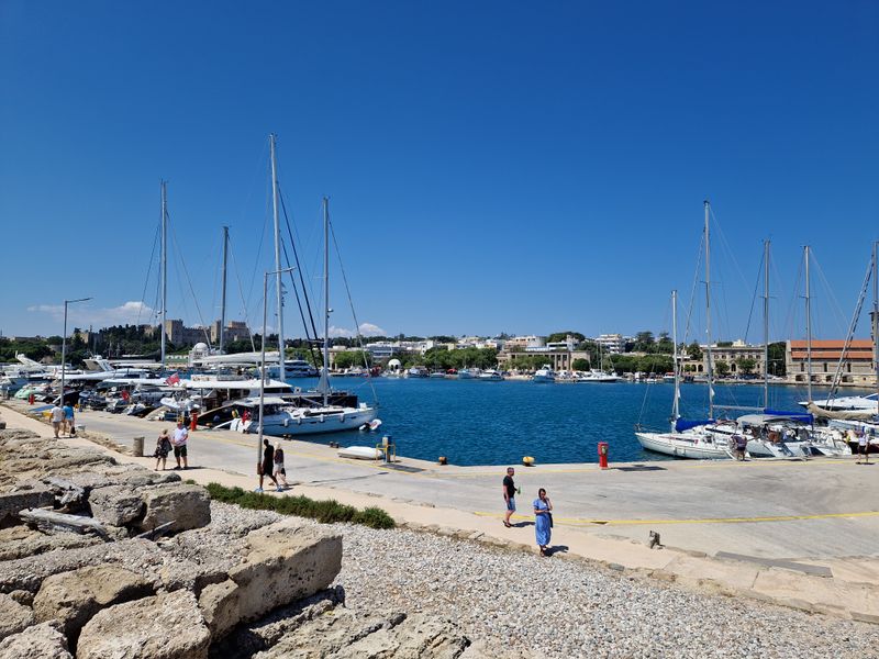 Do a sunset loop at Mandraki Harbor (windmills and fortress views)