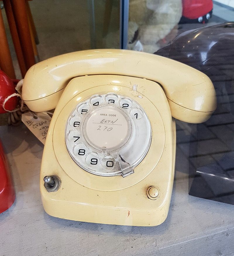 A rotary dial telephone nearby