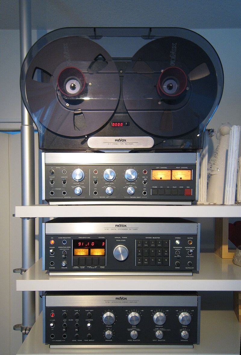 A stereo system or record player with stacked vinyls