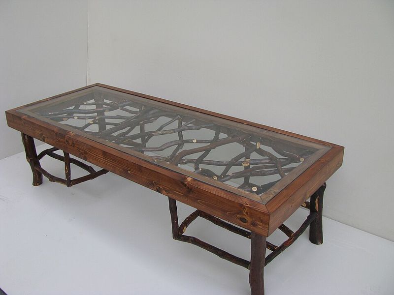 A large coffee table usually dark wood or glass