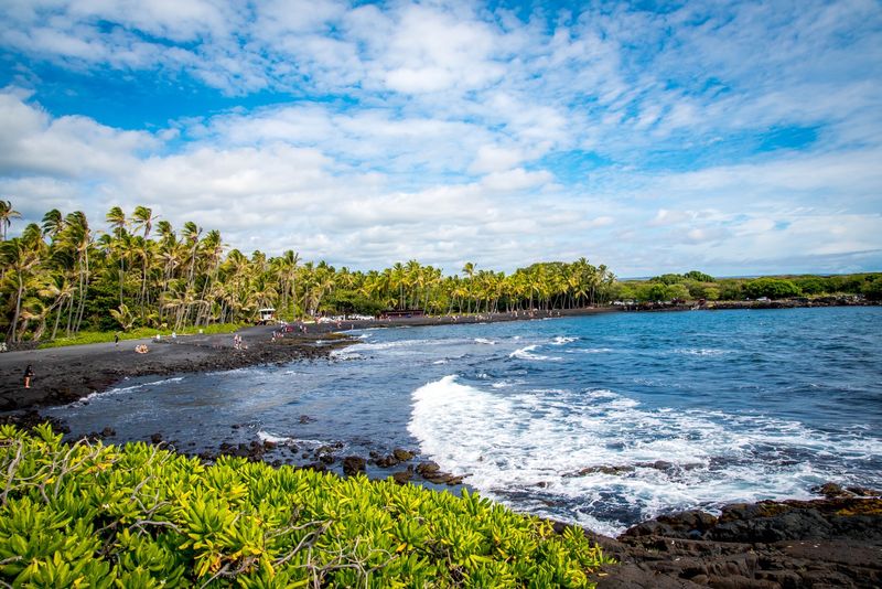 Visit Punaluʻu Black Sand Beach (for the scenery and turtle-spotting)