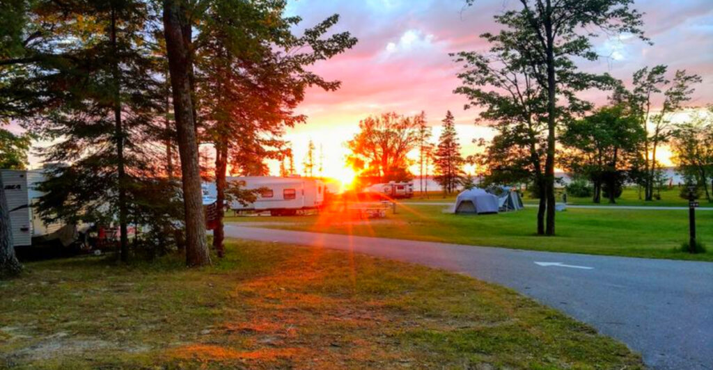 This 17,000-Acre Michigan Lake Park Has Glassy Morning Water, Sandy Beaches, and Campsites Right by the Shore