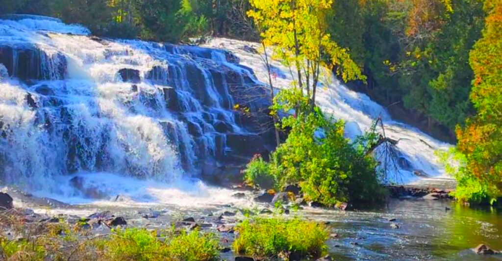 These Hidden Michigan Waterfalls Require Long Forest Drives, But the Views Are Absolutely Worth It