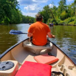 This Michigan Campground Lets You Kayak a Scenic River by Day and Fall Asleep Steps From the Water at Night