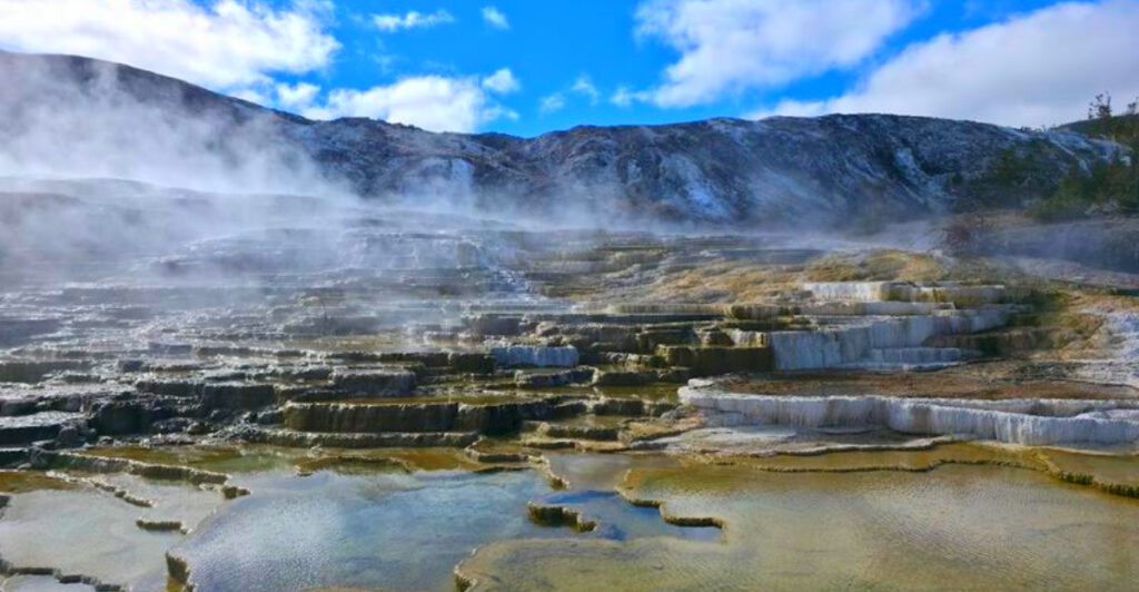This Iconic National Park Has Exploding Geysers, Roaming Bison, and Some of America’s Most Spectacular Landscapes
