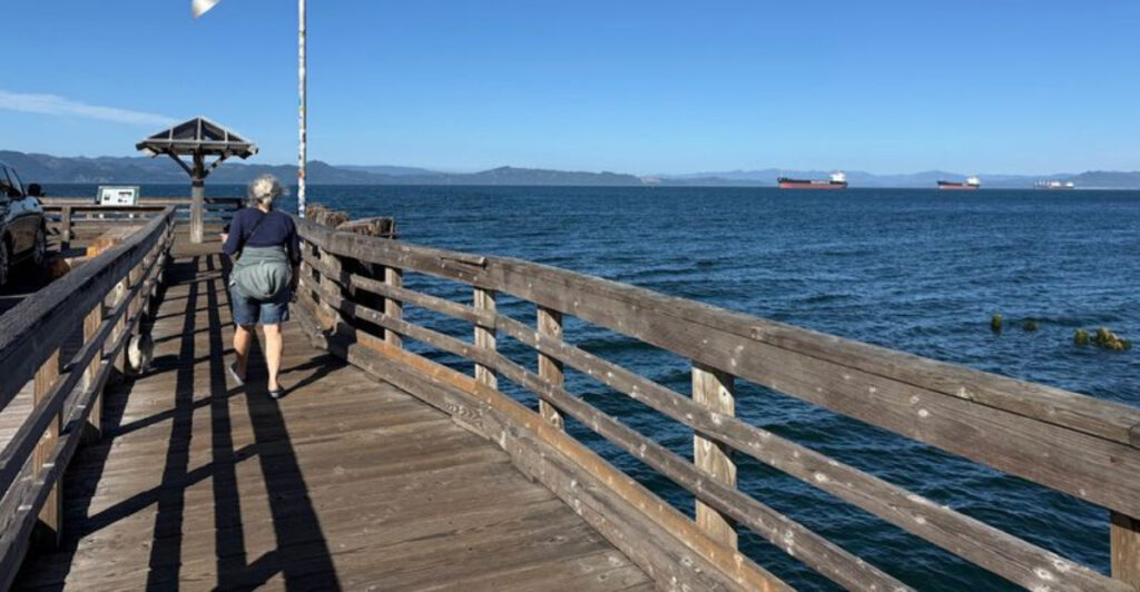 This Oregon Park Combines a Charming Viewing Pier, River Traffic, and Stunning Mountain Scenery