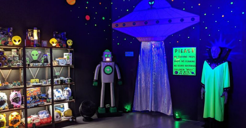 This Roswell Blacklight Spacewalk Turns A Downtown Storefront Into An Alien Planet