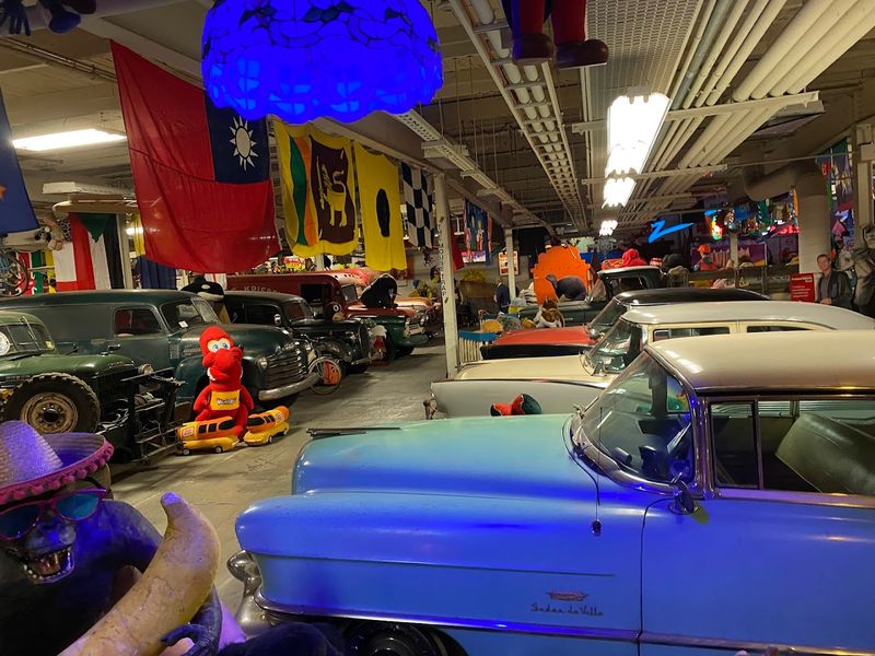 Vintage Cars Surrounded by the Signs of Their Era