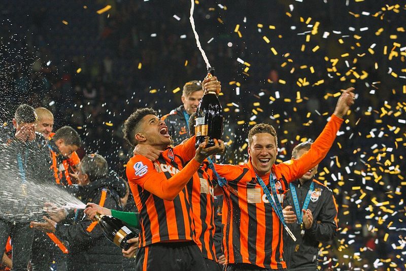 Champions Lifting the Trophy While Showered in Confetti Champions Lifting the Trophy While Showered in Confetti