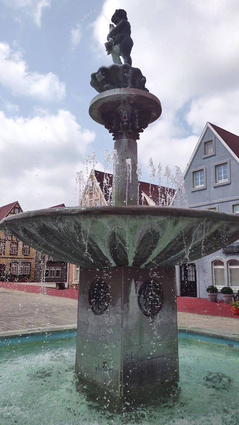 The Village Plaza, the Fountain Nymph, and the Koi Pond