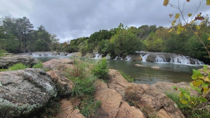 This Wild Oklahoma Fishing Spot Lets You Pitch a Tent on a Bluff Right Above a Waterfall