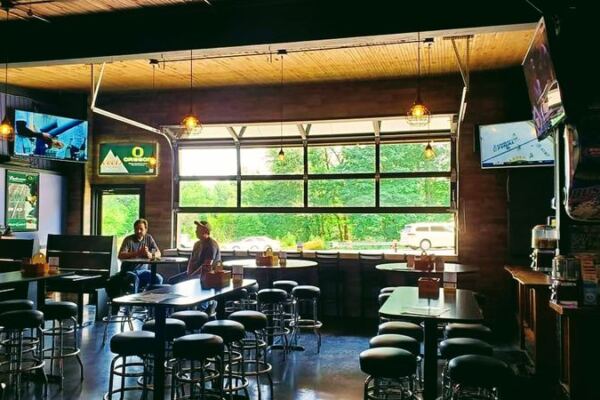 This No-Frills Oregon Roadhouse Pairs Live Music With Pinball, Pool, And Roll-Up-Door Patio Days