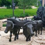 This Free Omaha Sculpture Park Has Giant Bronze Wagons, Bison, and Pioneers Across Six City Blocks
