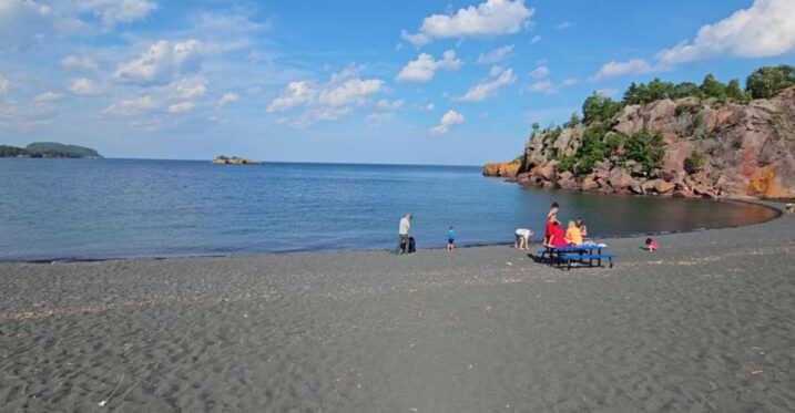 This Minnesota Beach Looks Volcanic, But Its Black Sand Has A Different Story