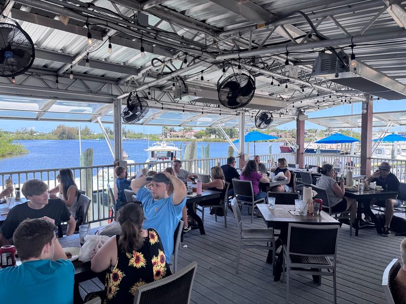 Outdoor Tables Where Boats Drift Past Your Meal
