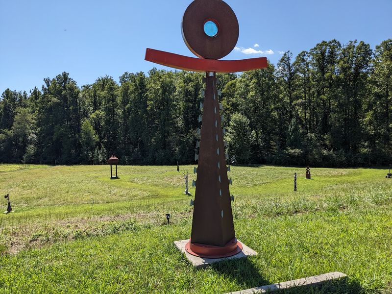 Sculptures Scattered Across a Mowed Grassy Field