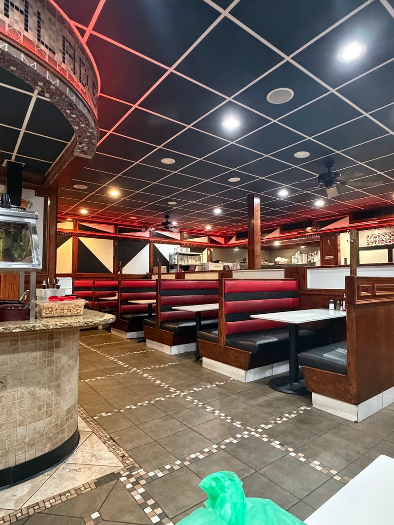 The Interior: Red Booths, Wooden Accents, and a Room Bigger Than You Anticipate The Interior: Red Booths, Wooden Accents, and a Room Bigger Than You Anticipate