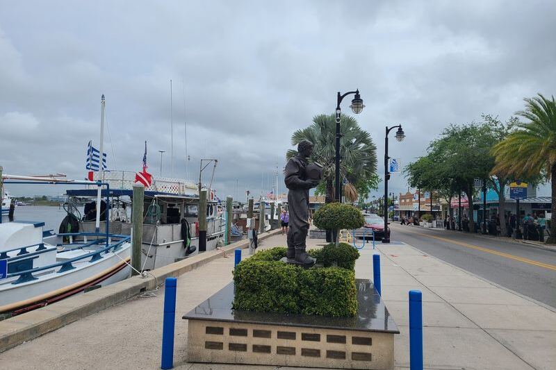 Dolphins Swim Past the Boardwalk While You Eat Fresh Seafood in Florida’s Tiny Tarpon Springs Sponge Docks