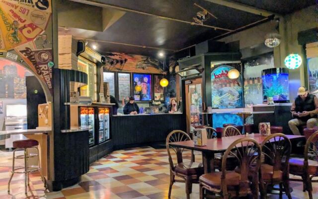 This Retro Olympia, Washington Pizza Joint Pairs Plate-Sized Thin-Crust Slices With Pinball and ’80s Posters