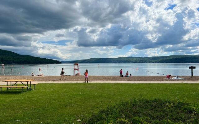 This Scenic New York State Park Beach Lets You Swim In Clear Otsego Lake For Just $7