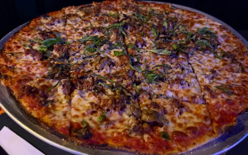 This Wisconsin Speakeasy Hides in an Old Italian Workers Club and Serves Tavern-Style Pies Diners Call Madison’s Best