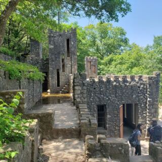 This Mysterious Oklahoma Castle Above a Roaring Waterfall Has Stairs and Caves to Explore