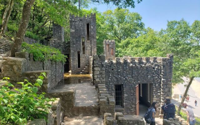 This Mysterious Oklahoma Castle Above a Roaring Waterfall Has Stairs and Caves to Explore