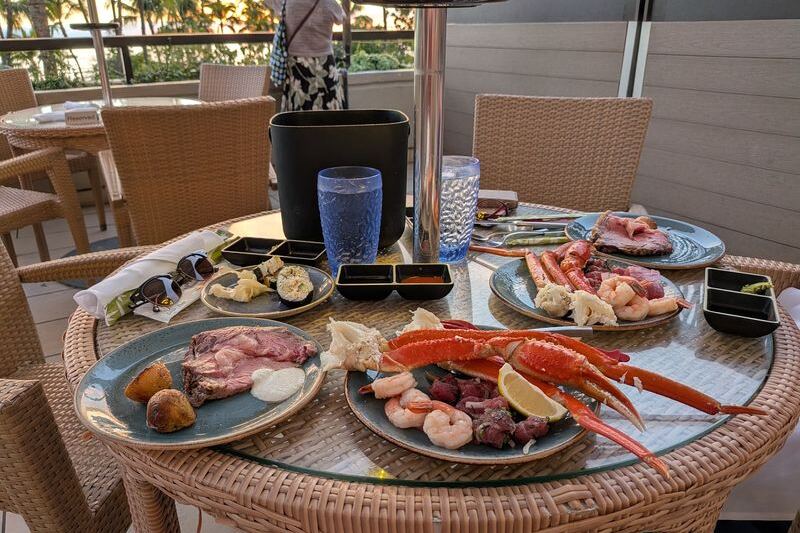 This Waikiki Seafood Buffet Piles On Snow Crab, Oysters, and Fresh Sushi While the Sun Sets Over the Beach