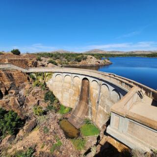 This Oklahoma Dam Towers Over a Still Lake With Views So Calm They Barely Look Real