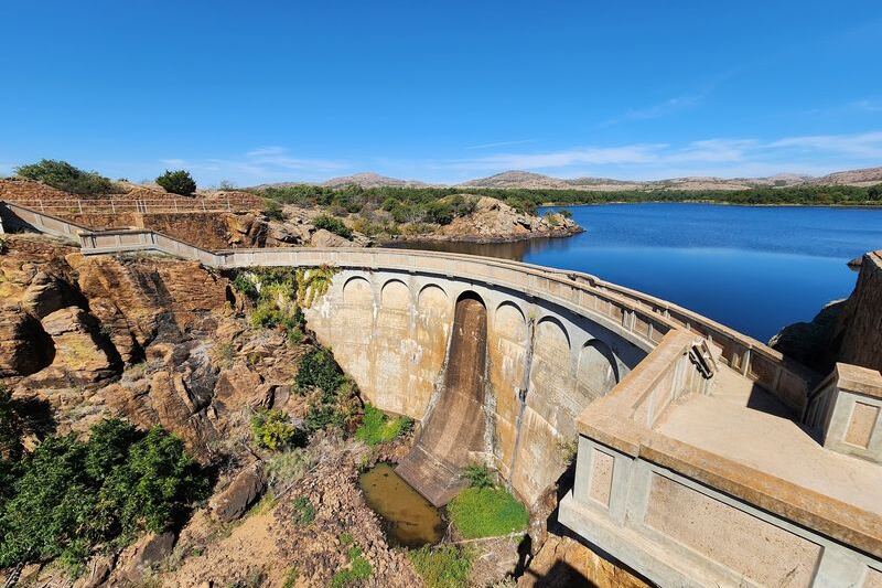 This Oklahoma Dam Towers Over a Still Lake With Views So Calm They Barely Look Real