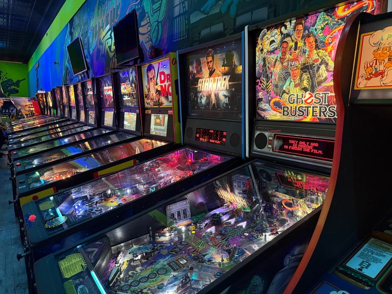 A Long Row of Pinball Tables Waiting for Flippers A Long Row of Pinball Tables Waiting for Flippers