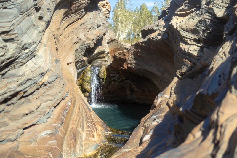 A Pool Wrapped in Curved Stone A Pool Wrapped in Curved Stone