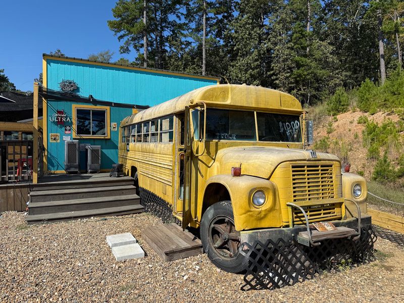 A Roadside Stop With a Bus Parked Out Front A Roadside Stop With a Bus Parked Out Front