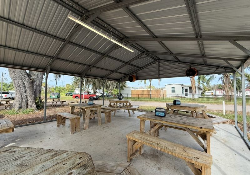 Picnic Tables Under Old Oaks and a Metal Roof