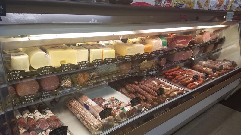 Prosciutto, Provolone, and a Long Glass Case Prosciutto, Provolone, and a Long Glass Case