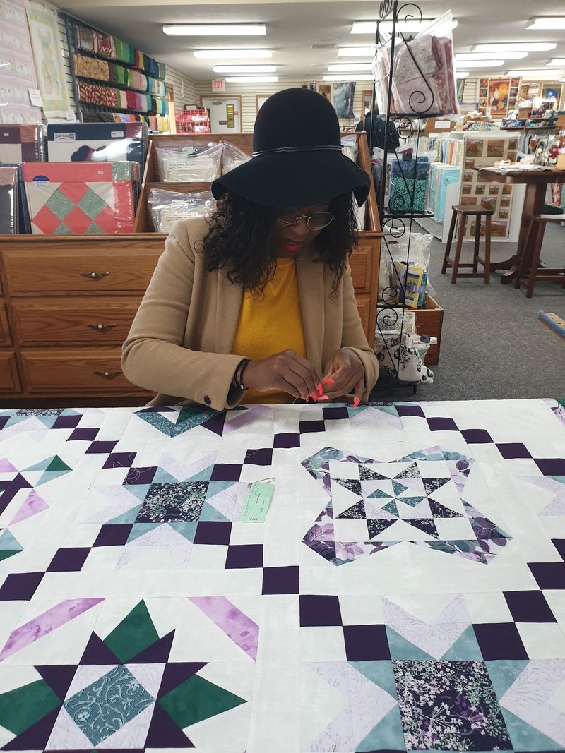 Quilt Repair And Women Stitching Around A Frame Quilt Repair And Women Stitching Around A Frame