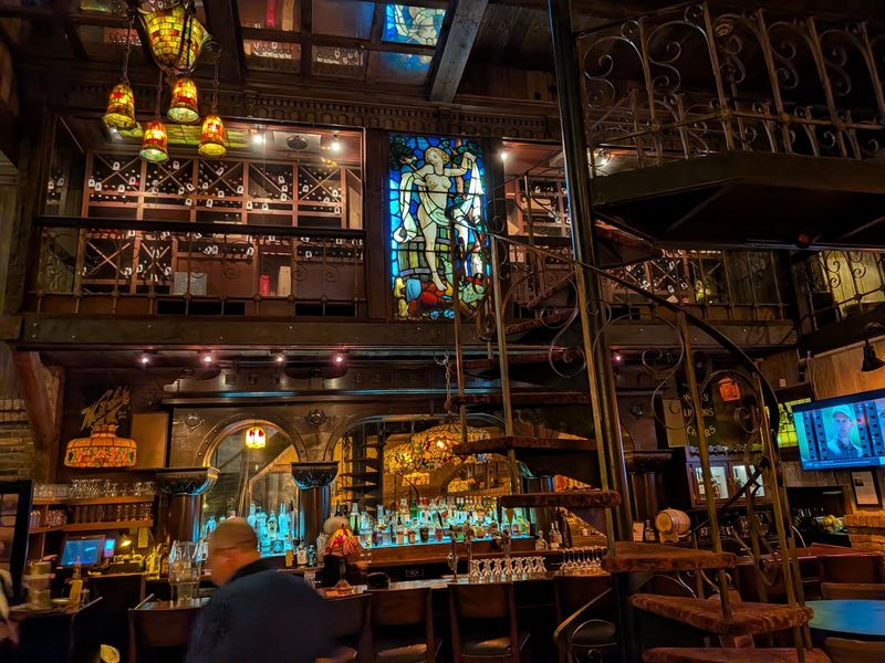 Stained Glass, Dark Wood, And Candle-Soft Light