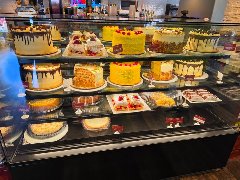The Bakery Case and Its Towering Cakes