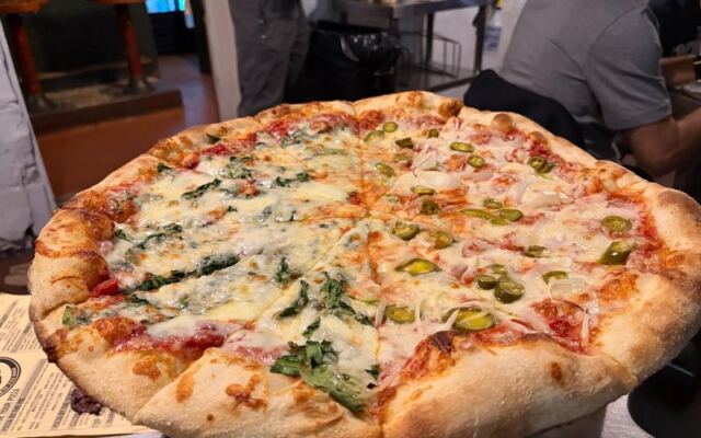 This Cash-Only Savannah, Georgia Pizza Joint Serves Giant Thin-Crust Slices Worth the Wait
