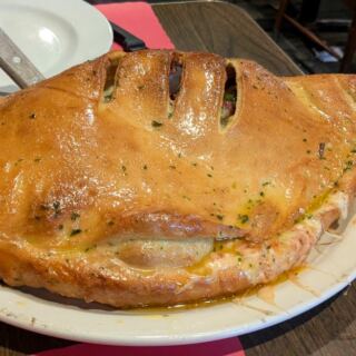 This Hidden Pittsburgh Restaurant Serves a Calzone Nearly as Wide as the Table