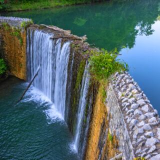 This Dreamy Arkansas Waterfall Spills Into a Brilliant Blue-Green Lake