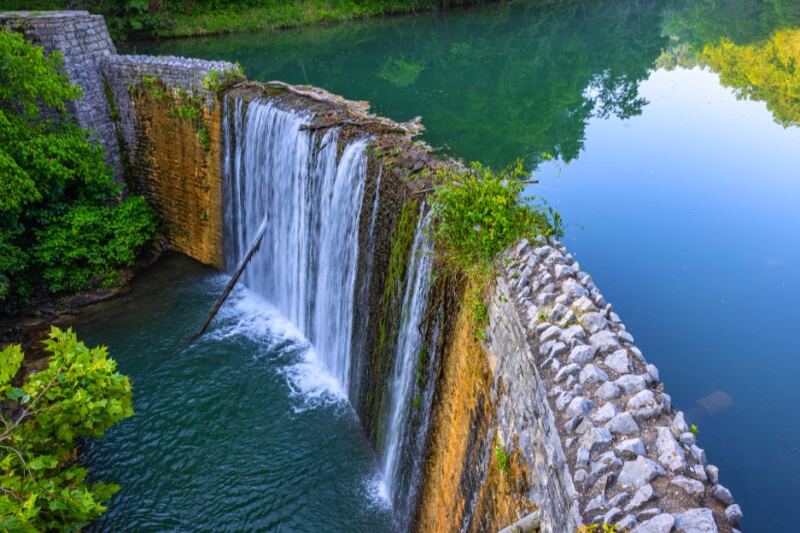 This Dreamy Arkansas Waterfall Spills Into a Brilliant Blue-Green Lake