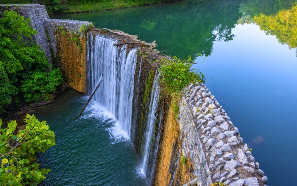 This Dreamy Arkansas Waterfall Spills Into a Brilliant Blue-Green Lake